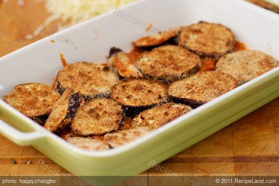 Arrange eggplant slices on tomato mixture.