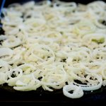 Coat a baking sheet with nonstick cooking spray and evenly spread the onions on the pan. 