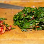 Cut green leafy part from central stems of Swiss chard. 
