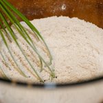 In a large bowl, whisk together 1 cup all-purpose flour, 1/2 cup whole wheat flour, baking powder, salt and baking soda until well mixed.