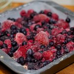 Sprinkle the frozen berries over the batter.