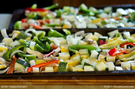 Toss the vegetables with olive oil, salt, black pepper and herbs in a large bowl, then spread onto one or two baking sheets.
