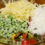Then in a large bowl, add the roasted vegetables, cheeses, peas, salt and black pepper to taste.