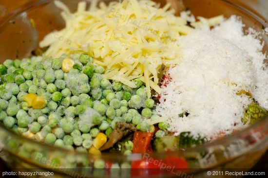 Then in a large bowl, add the roasted vegetables, cheeses, peas, salt and black pepper to taste.