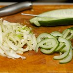 Half, seed and thinly slice the cucumber into half moon; and thinly slice the fennel.