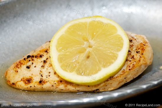 Slice the rest of the lemon and place a lemon slice on top of each chicken piece. 