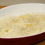 Place several layers of potato in the base of a well-greased round oven dish.