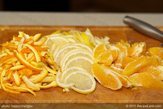 Separate the pulp and peel of oranges, thinly slice the whole lemon and orange peel.