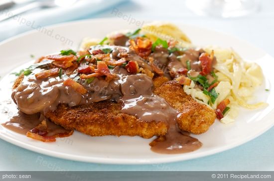 Place a schnitzel on each plate.