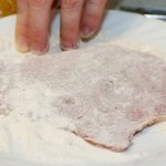 Dip each pork chop, thoroughly coating, first in the seasoned flour. 