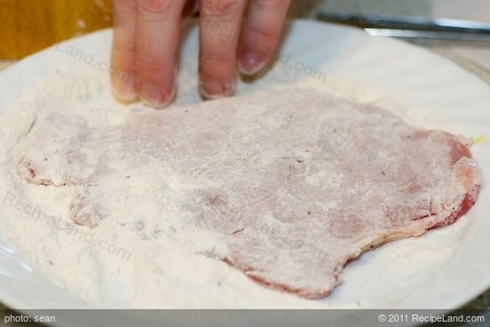 Dip each pork chop, thoroughly coating, first in the seasoned flour. 