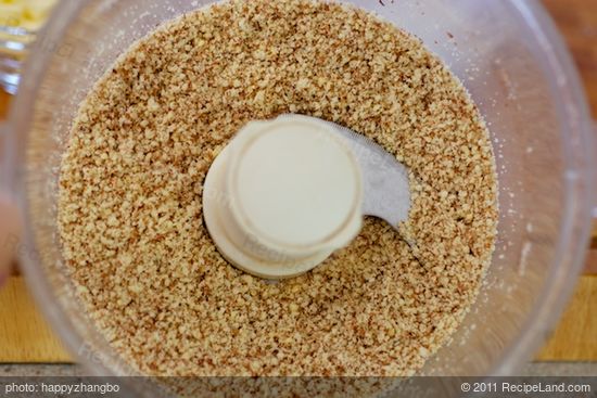 Grind the almonds in a food processor until finely ground.