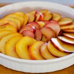 Lay the sliced peaches or nectarines and plums at a neat pattern over the almond topping. 