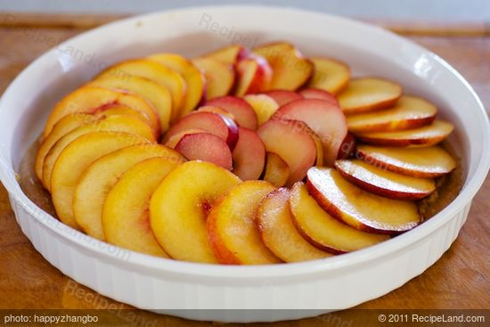 Lay the sliced peaches or nectarines and plums at a neat pattern over the almond topping. 