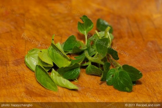 A few fresh basil and oregano leaves. Finely chop them.