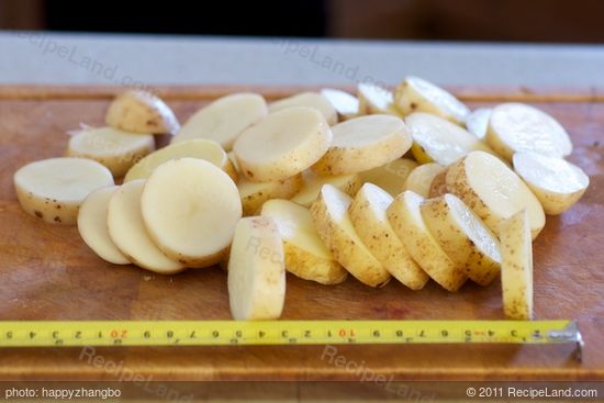 Preheat the oven and prepare the potatoes.