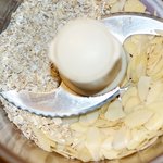 In a food processor, add the oats and almonds,