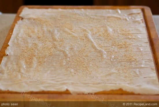 Place 1 phyllo sheet on a large cutting board or work surface
