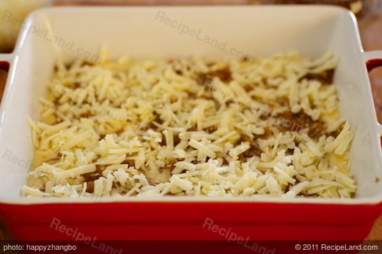 Spread half of the grated cheese over the onions.