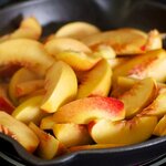 Add the peaches into the hot pan with the bubbling butter.