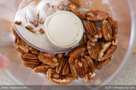 In a food processor, add 1/2 cup pecans and sugar.