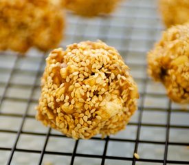 Double Peanuts and Honey Christmas Popcorn Balls with Sesame Coating