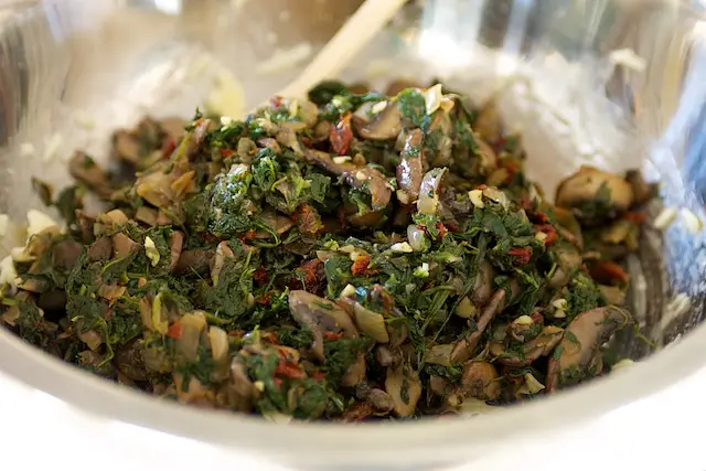 Add spinach mixture into cheese and egg mixture.