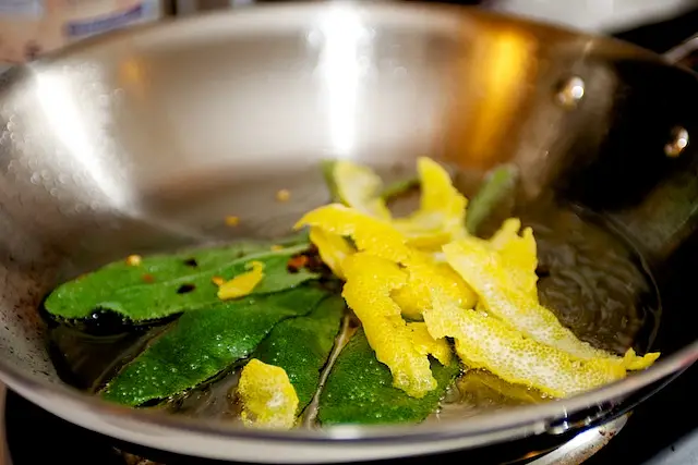 Add the sage leaves, lemon strips,