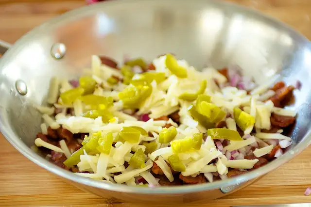 and top with shredded cheese. Set aside. 