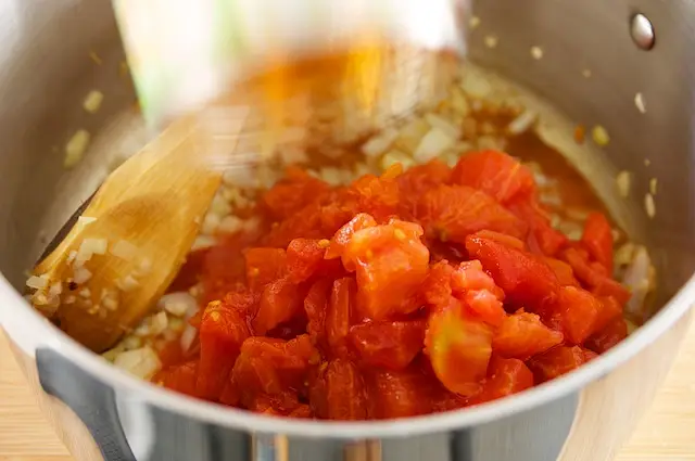 Add tomatoes with juice.
