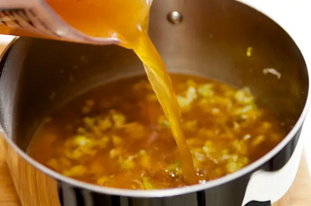 Pour in broth.