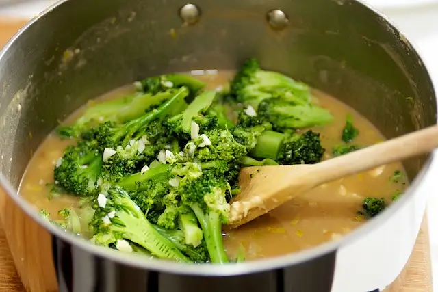 Add broccoli pieces to broth.