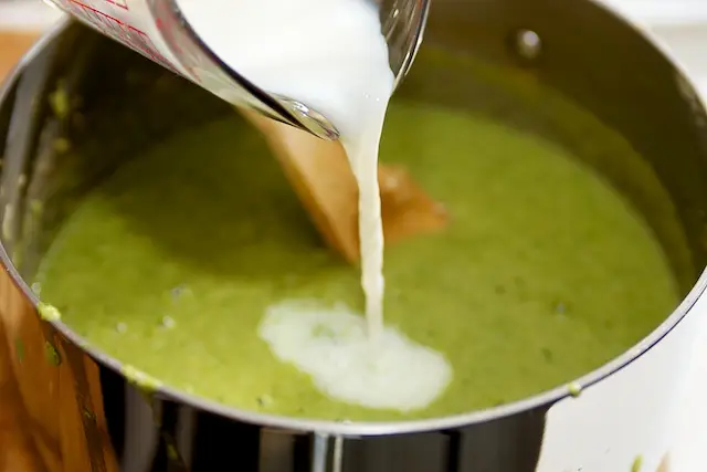 Just before serving, blend in milk,