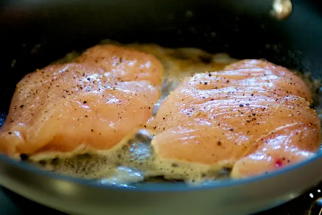 Add the chicken breasts into hot pan with bubbling butter.