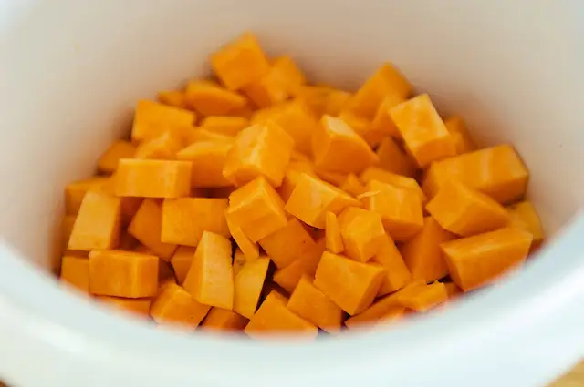 Add cubed sweet potatoes into crock pot.