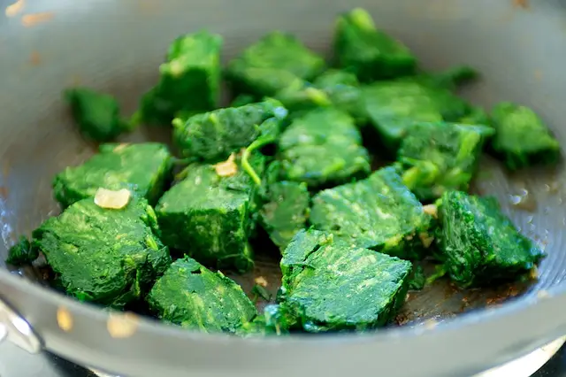 Add the frozen spinach into the pan, 