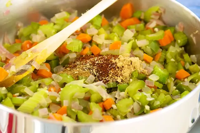 Stir in chili powder to taste, cumin, oregano, and ginger,