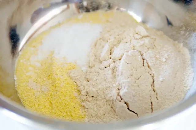In a mixing bowl stir together flour and cornmeal.  