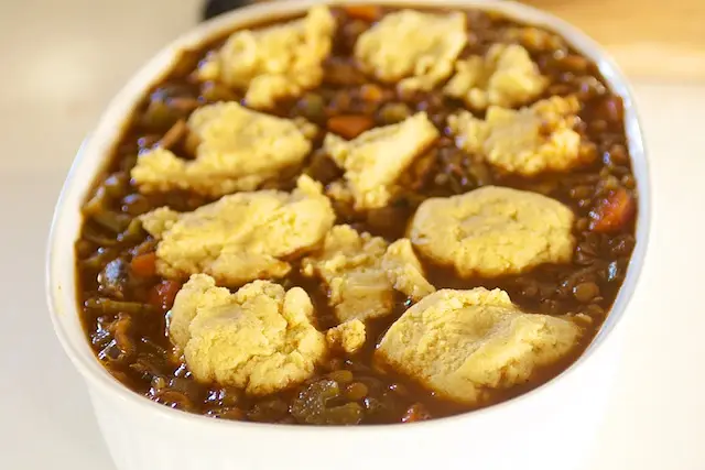 Spoon corn bread mixture on top of the chili.