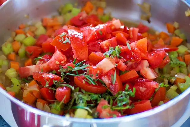 Stir in ½ teaspoon salt, tomato, basil, and rosemary.