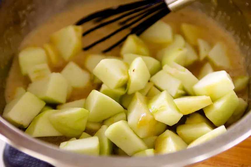 Add the apples into liquid mixture.