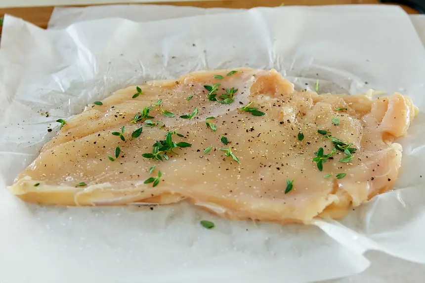 Flatten and season the chicken