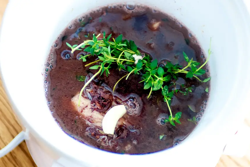 Add the red wine mixture to the slow cooker with a boquet garni