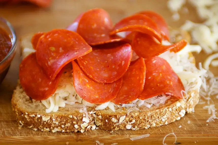 Then slices of pepperoni.