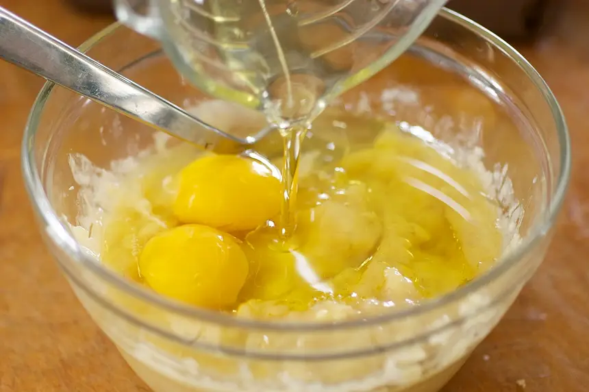Add oil, egg whites into bananas.