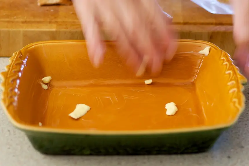 Lightly grease the dish with a small amount of butter. 