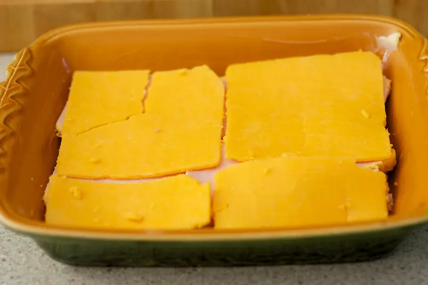 Lay slices of cheddar cheese on top,
