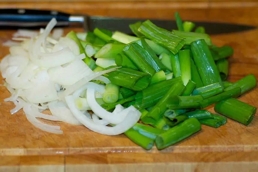 Thinly slice the onion and cut scallions into 2-inch pieces.