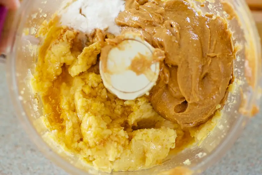Add peanut butter, vanilla extract, honey, baking powder and salt.