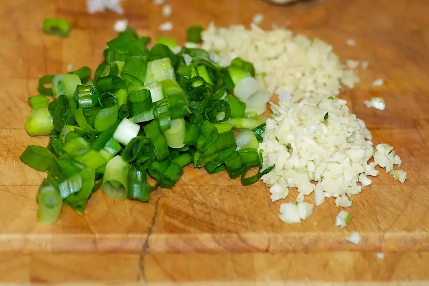 Meanwhile mince the garlic, ginger and slice the scallions.